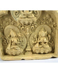 Gray stone carved relief showing two seated deities with ornate patterns, Thai Miniature Terracotta Shrine style, close-up.