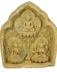 Brown terracotta Thai miniature shrine with three seated deities, ornate arch, and intricate patterns, close-up view.