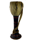 Brown wooden Thai tribal bongo drum with hourglass shape, vertical lacing, and woven strap, close-up view.