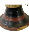 Close-up of the base of a black and red wood Thai Tribal Bongo Drum with visible cracks and worn edges.