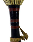 Close-up of black Thai tribal bongo drum with red bands and woven strap in good condition, against white background.