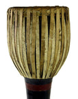 Close-up of a dark wood Thai tribal bongo drum with vertical natural fiber strips, in good condition.