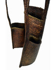 Natural rattan Thai baskets with handles, joined side by side, close-up on white background, 10"x6".