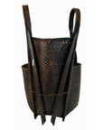 Dark brown woven rattan basket with two long straps, 10x6 inch base, 23.5 inch height, close-up view.