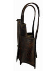 Dark brown rattan basket with two compartments and long handles, used as a decorative vase.