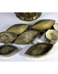 Vintage brass tiered betel nut box open on white surface, showing detailed metal craftsmanship.