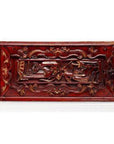 Reddish-brown hand-carved wooden treasure box with raised floral and animal motifs, close-up view.