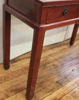 Light wood triple drawer desk with unique horse hoof feet on a pale wooden floor.