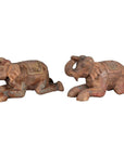 Close-up of two vintage Thai painted wood elephant sculptures with carved decorative patterns, from Chiang Mai.