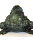Close-up of verde gris bronze pond frog sculpture with open mouth and bumpy body, shown against a plain background.