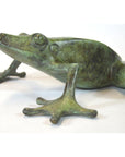Verde gris bronze pond frog sculpture with outstretched leg on white background, close-up view.