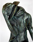 Verde gris bronze frog statue wearing a jacket and tipping a hat, cast in lost wax.