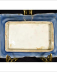 Blue porcelain dish with hand painted Asian design, vintage style, on decorative brass display stand.