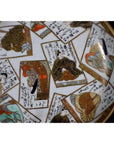 Multicolor porcelain plate with hand painted portraits, calligraphy, and traditional Asian patterns, close-up view.