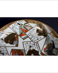 White porcelain plate with hand painted Japanese art and calligraphy on rectangular panels, vintage style, close-up.