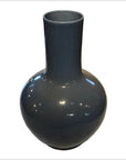 Close-up of blue crackle celadon vase with glossy hand-glazed finish and tall, narrow neck.