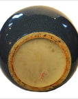 Close-up of blue crackle celadon ceramic vase base with textured glaze and red text label.