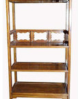 Brown wood bookcase with medallions, four shelves, and three decorative compartments, indoors.