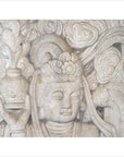 White stone Bodhisattva sculpture with closed eyes, hand-carved, holding a vase among swirling clouds.