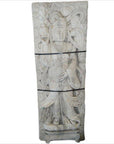 White stone Bodhisattva sculpture in flowing robes holding a vessel, surrounded by carved clouds.