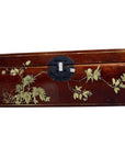 Red lacquered Chinese wooden dowry box with hand painted floral and bird designs, black metal clasp, close-up view.