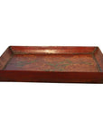 Close-up of a vintage Chinese hand-painted ornate tray, rustic red color with weathered finish and raised edges.