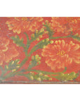 Red hand-painted Chinese tray with orange and yellow flowers, green stems; ornate floral design, close-up view.