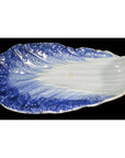 Blue and white porcelain leaf-shaped dish, vintage Chinese hand-painted, close-up on black background.