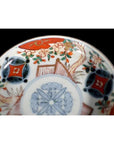 Close-up of a colorful porcelain plate with vintage Chinese hand painted floral and geometric patterns.