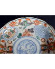 Close-up of colorful hand painted porcelain plate with intricate floral motifs and patterns, vintage Chinese style.