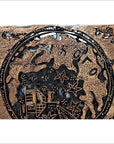 Close-up of vintage copper Batek ink block with ornate embossed star-shaped patterns.