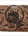 Close-up of a square copper ink block with vintage batik design, featuring a rocket, stars, and abstract patterns.