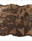 Close-up of vintage copper Batek ink block with engraved intricate floral and leaf patterns.