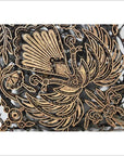 Close-up of vintage copper Batek ink block with intricate floral and bird design for textile printing.