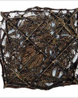 Close-up of a vintage copper batik ink block with intersecting lines and organic shapes in a square frame.