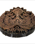 Close-up of vintage copper Batek ink block with detailed floral and leaf designs, used for fabric stamping.