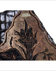 Close-up of vintage copper Batek ink block with intricate black and gold floral pattern on mesh.