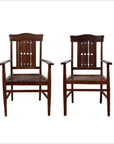 Brown wood armchairs with pierced slats and bonnet-style rails, side by side, vintage Dutch Colonial style.