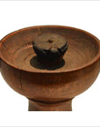 Close-up of a vintage hand-carved wooden candle holder with Dutch design on a white background.