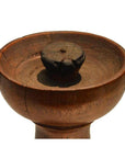 Close-up of a vintage hand-carved wooden candle holder with Dutch design on a white background.