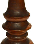 Close-up of dark brown polished wood candle holder, hand carved with Dutch influence and smooth curved details.
