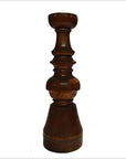 Brown hand-carved wooden candle holder with Dutch geometric design on a white background.