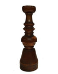 Brown hand-carved wooden candle holder with Dutch geometric design on a white background.