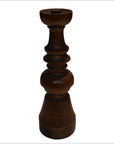 Close-up of a dark brown hand-carved wooden candle holder with vintage Dutch style on a white background.