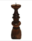 Brown hand-carved wooden candle holder with Dutch influence, pointed spike on top, close-up view.