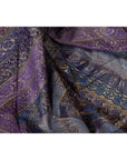 Purple silk fabric with gold and silver embroidery, draped in soft folds, close-up.