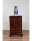 Blue and white porcelain vase on vintage Japanese display cabinet with red Negora lacquer and gilded calligraphy.