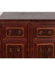 Close-up of red Negora lacquer display cabinet with gilded calligraphy on panels, vintage Japanese style.