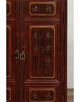 Close-up of red negora lacquer Japanese display cabinet with gilded calligraphy and ornate brass handles.