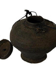 Brown woven farmer's basket with wide body and narrow neck, vintage Philippines, on white background.